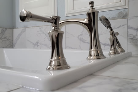 Plumber installing a watersense bathroom faucet in a fresno home