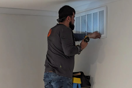 Technician replacing a hepa filter in a fresno ca home